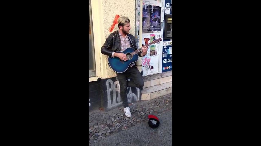 Street musician sings - original singer comes and joins him